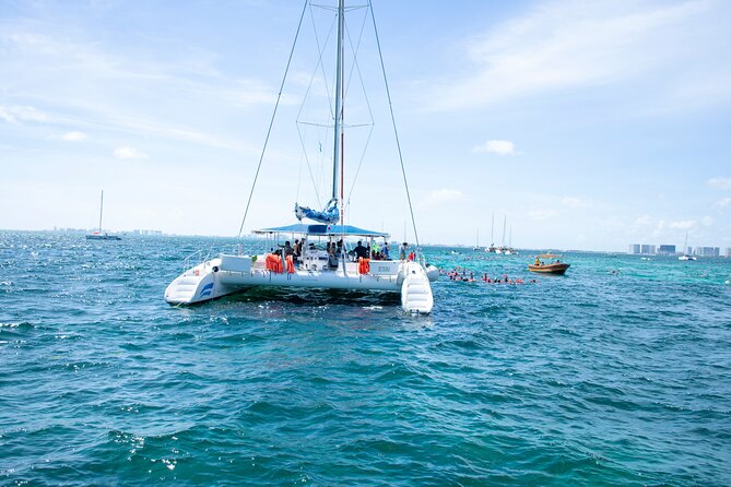 Isla Mujeres Tour on Catamaran with Snorkel, Open Bar, Buffet & Beach club - On-board party energy: games, music, and an easy-going crew